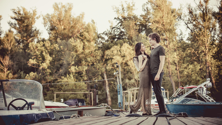 Romantic couple on the pier. Artistic toning.