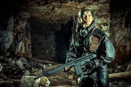 Beautiful woman soldier in leather clothing with the gun