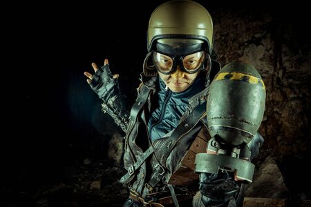 Soldier woman with the bomb on post apocalyptic background.の写真素材