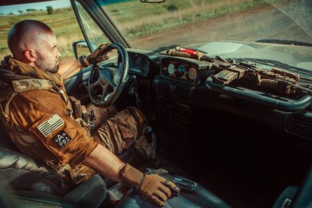 Bald soldier in uniform is driving military vehicle.の写真素材