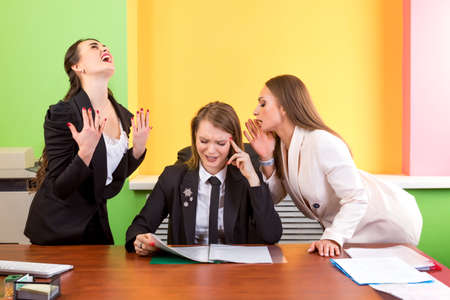 Image of three successful businesswomen interacting at meeting