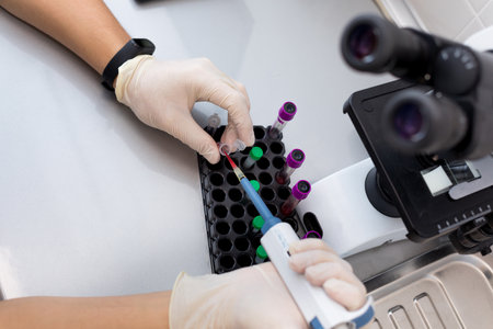 Technician holding blood tube test in the research laboratoryの写真素材