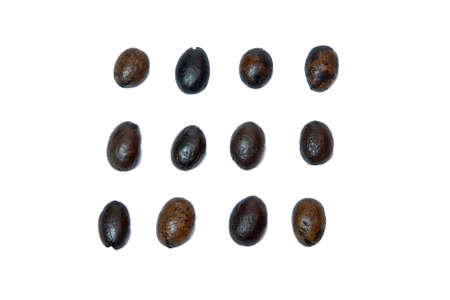 Roasted coffee beans piled from above on a white backgroundの写真素材