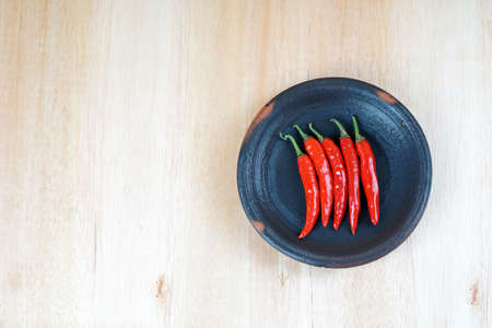 The chili on the black dish, isolated on white backgroundの写真素材