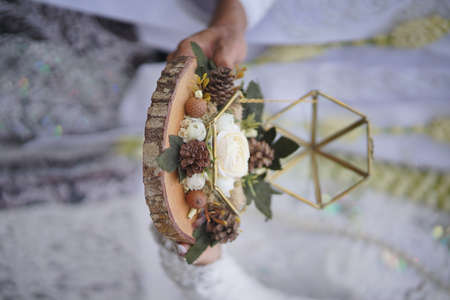 Engagement ring box in bride hands. Closeup of woman palms holding jewellery. Love, Wedding, Proposing, Marriage concept. Rustic chic styleの写真素材