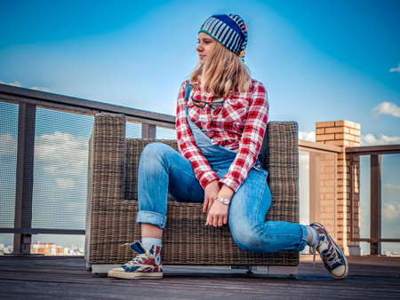 Seated woman wearing alternative clothes on a streetの写真素材
