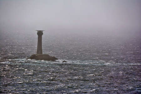 A lighthouse in the fog