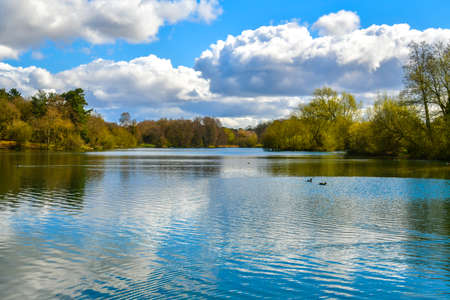 beautiful view of the lake, a walk on a hot sunny day encourages you to take a bath, silent blue water, white clouds in the blue skyの写真素材