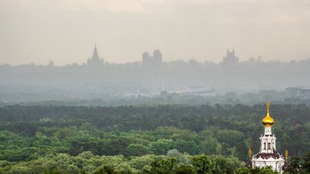 Chapel's dome is shining under the rays of morning sun and standing out sharply against the city skyline on the horizon.の写真素材