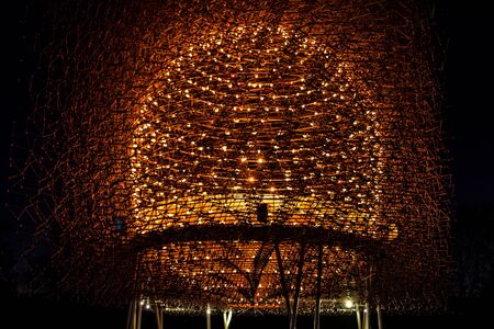 Hive of light and steel illuminated at night. Lights and steel are constructed in a form of hive and illuminated at night symbolising natural hiveの写真素材