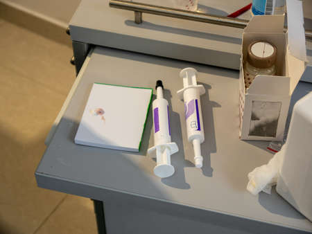 Dentist's table with a set of accessories for filling teeth lying on it.