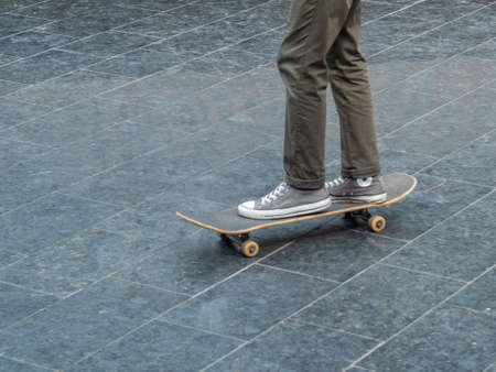 Leisure activity. Sportive lifestyle. Young skateboarder in the public park. Extreme sports are very...