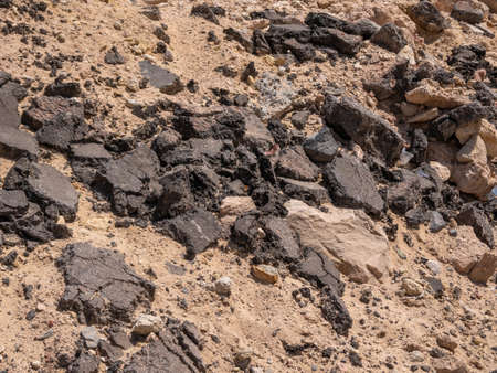 A pile of broken asphalt from the old road. close-up.