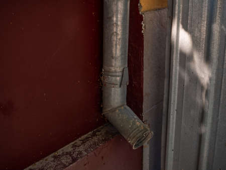 Drain pipe on the brown brick wall. Downspout.の写真素材