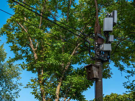 Concrete pole with communication boxes for internet or mobile phone and birdhouse.の写真素材