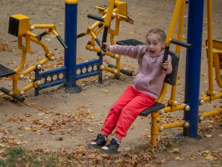 Sports ground. A 5-6 year old girl is engaged in a sports simulator.