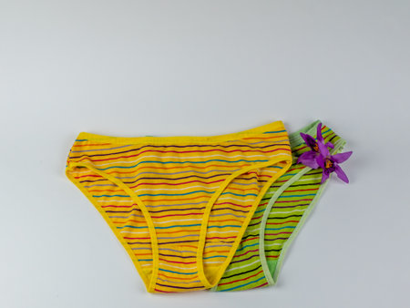 A pair of classic womens cotton panties on a light background close-up. Underwear beauty, comfort, fashion. Creative beauty concept of womens underwearの写真素材