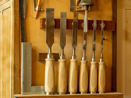 Carpentry workshop. Instruments. Close-up of tool kits hanging on the wall.の写真素材