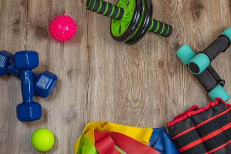 Sports and training equipment for fitness and physical education. Dumbbells, fitness roller, spiky and smooth acupuncture balls, ab and back roller, elastic bands. Concept of active lifestyleの写真素材