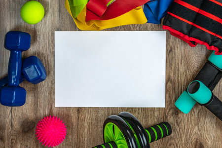 Sports and training equipment for fitness and physical education. Dumbbells, fitness roller, spiky and smooth acupuncture balls, ab and back roller, elastic bands. Concept of active lifestyleの写真素材