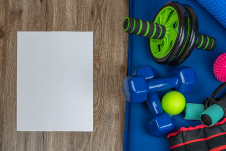 Fitness accessories. Close-up of dumbbells for arms and legs, weights for legs, balls for acupuncture points on body, wheel for training the press and back, a roller for fitness and yoga. Copy space.の写真素材