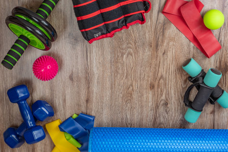 Set of equipment for fitness and physical education. Dumbbells, leg weights, fitness roller, elastic bands, spiky and smooth acupuncture balls, abs and back roller. Concept of health and longevityの写真素材