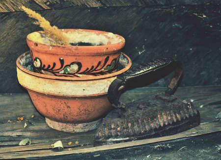 Vintage pot and iron with old background.Image with a feeling of abandonment and discardingの写真素材