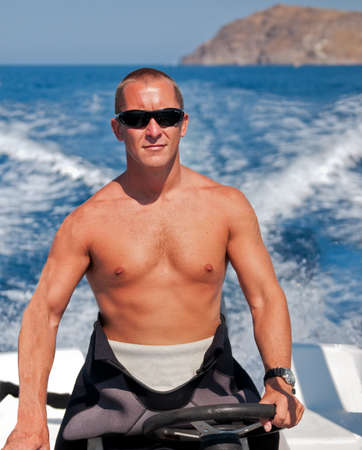 Diver driving speedboat to a dive siteの写真素材
