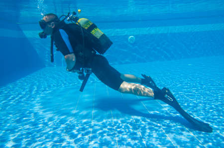 Young male learning to Scuba Dive in a Swimming Pool