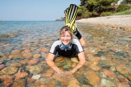 Beautiful young lady smiling and relaxing in the sea
