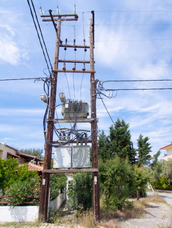 Electricity sub station on wooden poles in a villageの写真素材