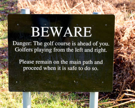 Sign warning people of golfers ahead