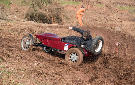 Worcester , UK - March 13 2016 : Competitors take part in a hill climb to see who can drive their car furthest up a muddy hillside. This was a free to enter event with no photography restrictions.のeditorial素材