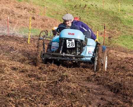 Worcester , UK - March 13 2016 : Competitors take part in a hill climb to see who can drive their car furthest up a muddy hillside. This was a free to enter event with no photography restrictions.のeditorial素材