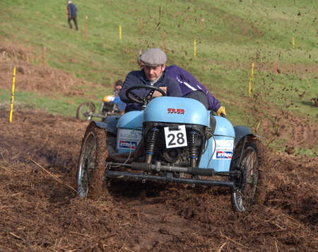 Worcester , UK - March 13 2016 : Competitors take part in a hill climb to see who can drive their car furthest up a muddy hillside. This was a free to enter event with no photography restrictions.のeditorial素材