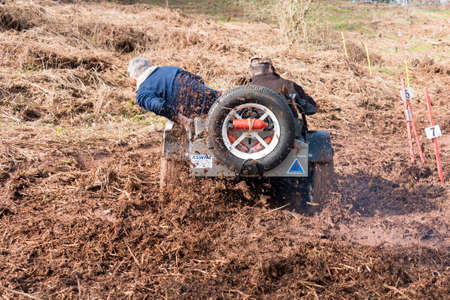 Worcester , UK - March 13 2016 : Competitors take part in a hill climb to see who can drive their car furthest up a muddy hillside. This was a free to enter event with no photography restrictions.のeditorial素材