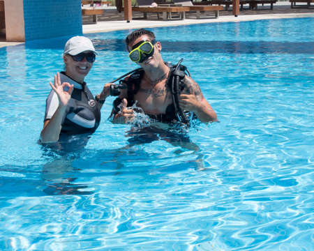 Paliouri,Greece - June 15 2016: Young  man tries a scuba dive in a pool with an instructor.Scuba diving is a fun sport enjoyed by many people.のeditorial素材
