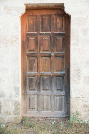 Old wooden door showing signs of wear and tearの写真素材