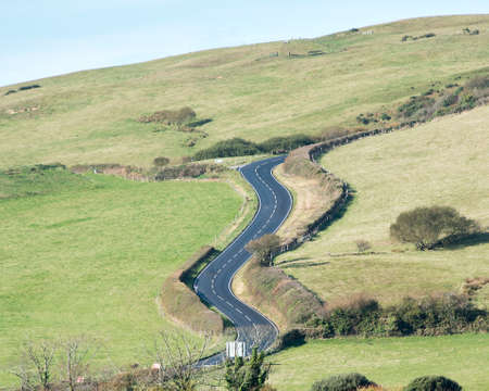 A road twists and turns up a hillside