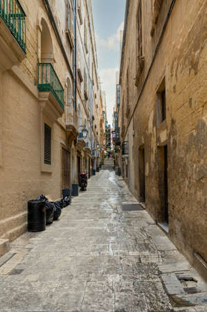 Narrow street leading to some steps in Valletta the capital city of Malta.の写真素材