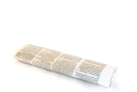 rolled up newspaper on white backgroundの写真素材