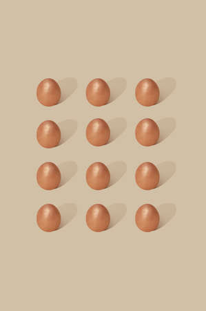 Powdered eggs arranged in a rectangle on a beige background. Gentle Easter 2021 concept. Elegant...
