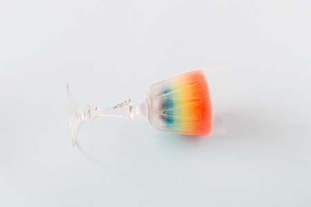 Frozen rainbow drink cocktail on a blue background. Colorful summer concept for parties and enjoyment.の写真素材