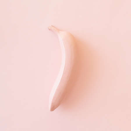 Painted in pink banana fruit on a pink background. Monochrome fruit conceptの写真素材