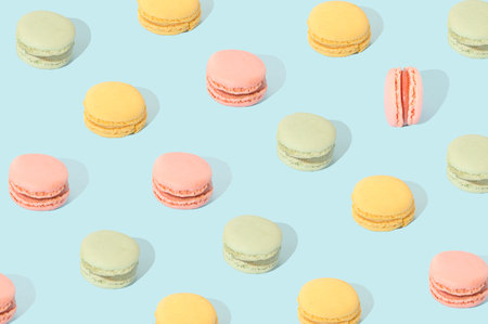Macarons in different pastel colors arranged in a pattern. Sweet food cake conceptの写真素材