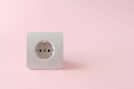 Power plug on a pink background with large copy space. Electricity conceptの写真素材