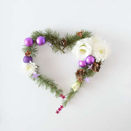 Christmas heart frame made of natural Christmas items, Christmas balls, flowers, pinecones and other decorations. Space for text.の写真素材