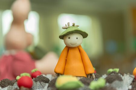 Tray with assorted candies of different flavors. Personalized and decorated sweets for the farm or rural theme. Handmade candies in the shape of scarecrow, corn, tomatoes and carrots. Selective focus.の写真素材