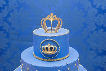 Fake blue birthday cake with a crown on top.の写真素材