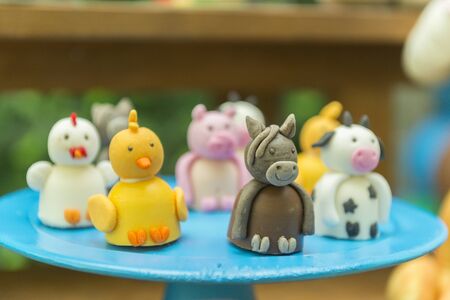 Kids Party Decoration - Farm Theme. Shaped candy personalized. Cake table detail. Handmade sweets with great care. Childhood and joy concept. Copy space Selective focus.の写真素材